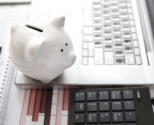 Save money laptop and piggy bank