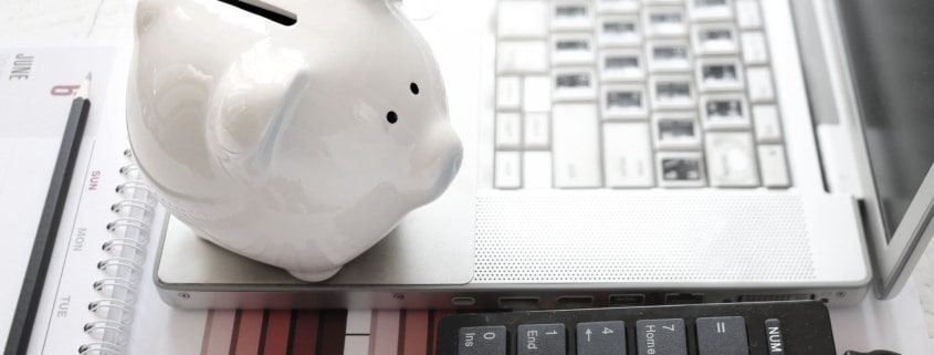 Save money laptop and piggy bank