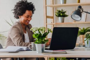 managed services agreement working business woman with a computer and plants