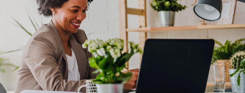working business woman with a computer and plants