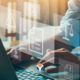 man on laptop with images containing icons relating to compliance