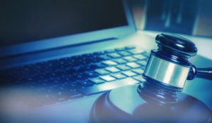 This image shows a gavel and a laptop as cybersecurity is important for law firms.