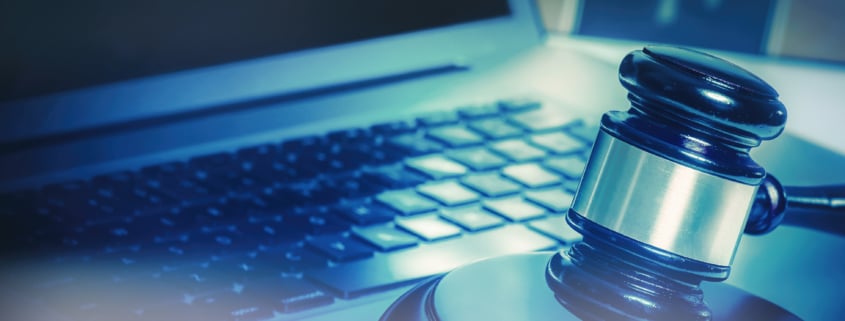 This image shows a gavel and a laptop as cybersecurity is important for law firms.