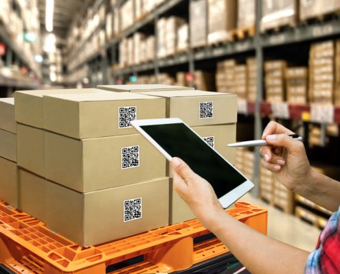 A warehouse worker managing supply chain risks