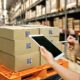 A warehouse worker managing supply chain risks