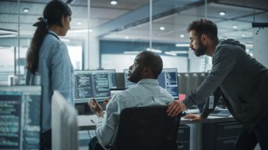 IT programmers considering the benefits of outsourcing cybersecurity